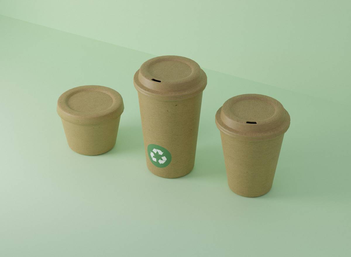 Stylish decor insulated wine and coffee cup on a bamboo coaster beside a wine bottle and coffee beans